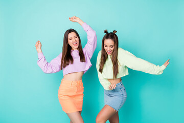 Sticker - Portrait of nice-looking attractive lovely pretty charming fashionable cheerful cheery brown-haired girls dancing having fun isolated on bright vivid shine vibrant blue color background