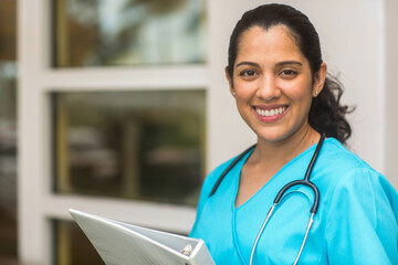 Wall Mural - Happy Hispanic medial provider at work stock photo.