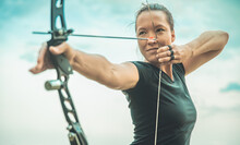 Archery, Young Woman With An Arrow In A Bow Focused On Hitting A Target