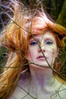© ullision - young beautiful sexy redhead woman with her beautiful gorgeous red hair caught in a pine branch.