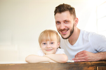 A happy family. Portrait of a young handsome father and cute little daughter. Father's day.