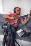 Fototapeta  - Guitarist making video lessons and tutorials for internet vlog website classes.