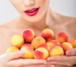 © Svetlana Fedoseeva - Beautiful woman holding a juicy apricots. Perfect skin. Professional makeup.