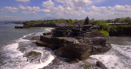 Wall Mural - Waves beat against rocks of Tanah Lot Temple. Aerial view, Bali, Indonesia.