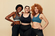 © puhhha - Diverse. Group Of Women With Different Figure Portrait. Smiling Multicultural Diversity Models In Fitness Clothes Posing On Beige Background. Body Positive As Lifestyle.