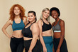 © puhhha - Diversity. Group Of Women Of Different Race, Figure And Size Portrait. Smiling Multi-Ethnic Female In Sportswear Posing On Beige Background. Body Positive As Lifestyle.