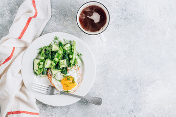 Wall Mural - Healthy breakfast with eggs and cucumber salad with coffee on light gray background. Flat lay. Minimal concept