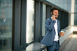 © JustLife - Portrait of handsome businessman. Man using phone.
