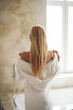 © JustLife - Beautiful woman wearing a bathrobe. Young happy woman enjoing in hotelroom.