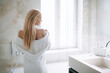 © JustLife - Beautiful woman wearing a bathrobe. Young happy woman enjoing in hotelroom.
