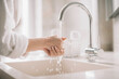 © JustLife - Close up of woman wash her hands.