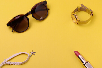 a pair of female or male sunglasses as the means of sun protection or fashionable accessories on yellow background