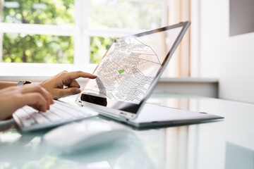 Female Executive Looking At Cadastre Map