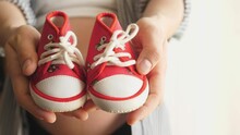 Female Hands Showing Baby Little Shoes Close Up Newborn Pregnancy Concept