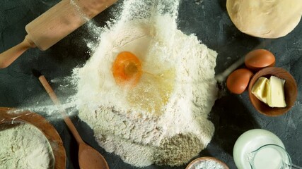 Wall Mural - Super slow motion of raw egg falling into pile of flour. Filmed on high speed cinema camera, 1000 fps.