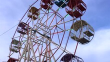 Underside View Of A Ferris Wheel With Blue Sky
