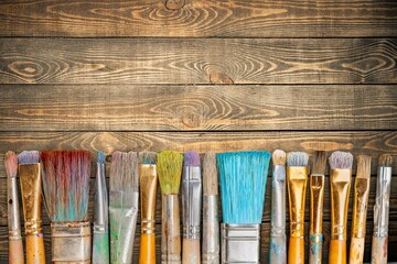 Wall Mural - A row of artist paint brushes on desk