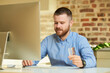 © Roman Tyukin - A man with a beard types a credit card information to do online shopping at home. A guy doing an online payment on the internet on a desktop computer in his apartment.