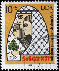 Wall Mural - Solidarity for the Palestinian cause on old stamp of DDR