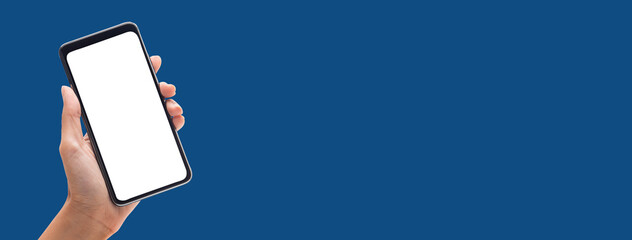 Hand holding the black smartphone on colorful blue banner background with blank screen, Clipping path.