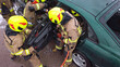 © CameraCraft - Team off Firefighters trying to cut open car door to save person involved in the accident.