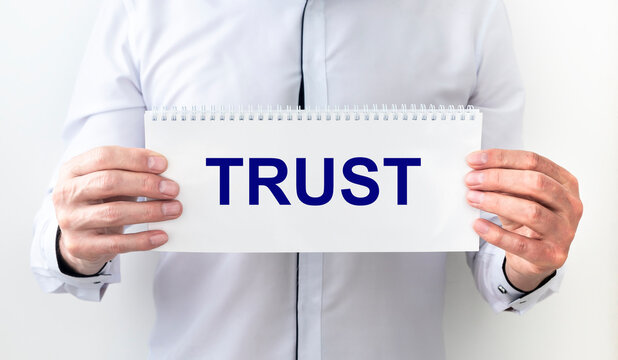 Trust word in hand, word on piece tear paper