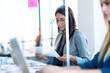 © nenetus - Two business women work with laptops on the partitioned desk in the coworking space. Concept of social distancing.