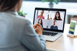 © nenetus - Female employee speaking on video call with diverse colleagues on online briefing with laptop at home.
