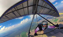 Happy Smiling Girl Hang Glider Pilot Shows Thumb Up High In The Sky.