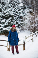 Wall Mural - A young woman in winter clothes enjoying a cold day in Colorado, USA