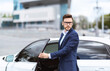 © Prostock-studio - Successful banker near his car on street of megapolis