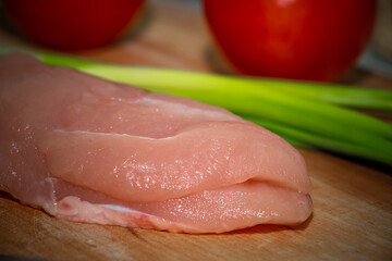 Wall Mural - Chicken fillet with vegetables on a cutting board