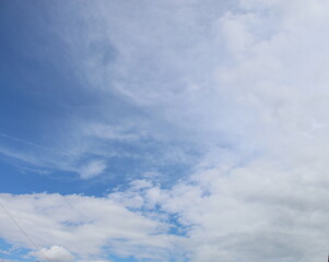 Blue pastel sky with white clear clouds