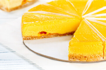 Wall Mural - Fresh cheesecake with mango fruit. Close-up.