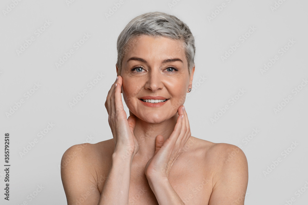 Mature Beauty. Portrait Of Nude Beautiful Middle-Aged Woman Touching