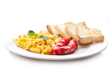 Breakfast with Four pieces of Toast with two beef sausages and scramble eggs adorned with leaves. Isolated on a white background.