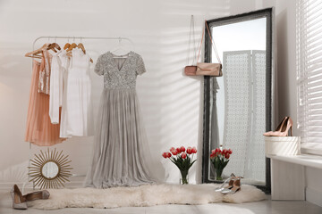 Wall Mural - Rack with stylish women's clothes and mirror indoors. Interior design