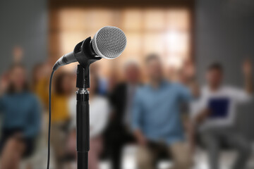 Modern microphone and people at business training indoors, closeup