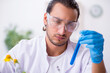 © Elnur - Young male chemist working in the lab