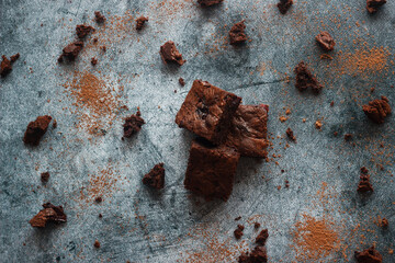 Tasty chocolate brownie with cherry. Pieces of cake on the table