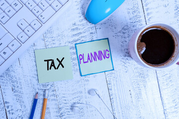 Handwriting text writing Tax Planning. Conceptual photo analyzing financial income and planning business accounting Writing equipment and computer stuff plus drinks placed above wooden table