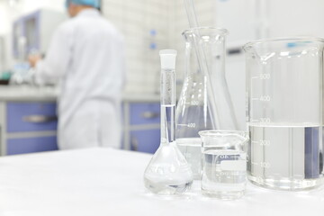 blur male scientist working in a chemistry science laboratory with flask, beaker and glassware conta