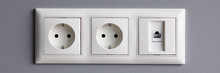 Modern White House Outlet On Gray Wall Closeup Object