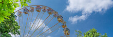A Beautiful Old Ferris Wheel With Blue Sky Background, Banner