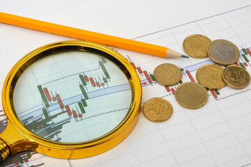 Items of a businessman. Futures, pencil, magnifier and money.