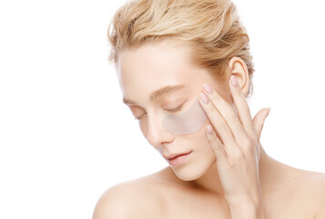 beautiful woman holding collagen eye patch with one hand, isolated on white background. perfect clea