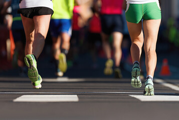 Wall Mural - Marathon running race, people feet on city road