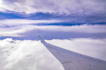 on an airplane in the sky above clouds