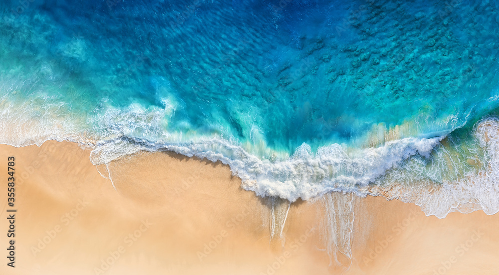 Beach and waves as a background from top view. Blue water background from drone. Summer seascape from air. Travel image - obrazy, fototapety, plakaty 