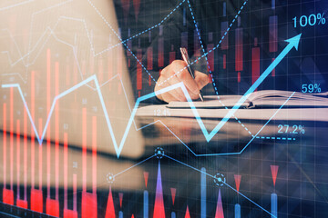 Double exposure of businessman with laptop and stock market forex chart.